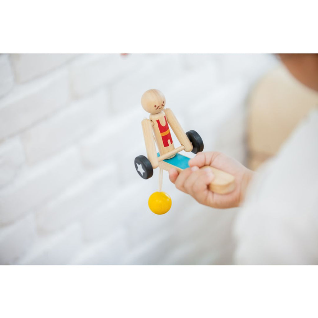 Kid playing PlanToys Weightlifting Acrobat