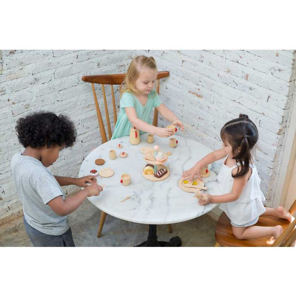 Kid playing PlanToys Bakery Stand Set