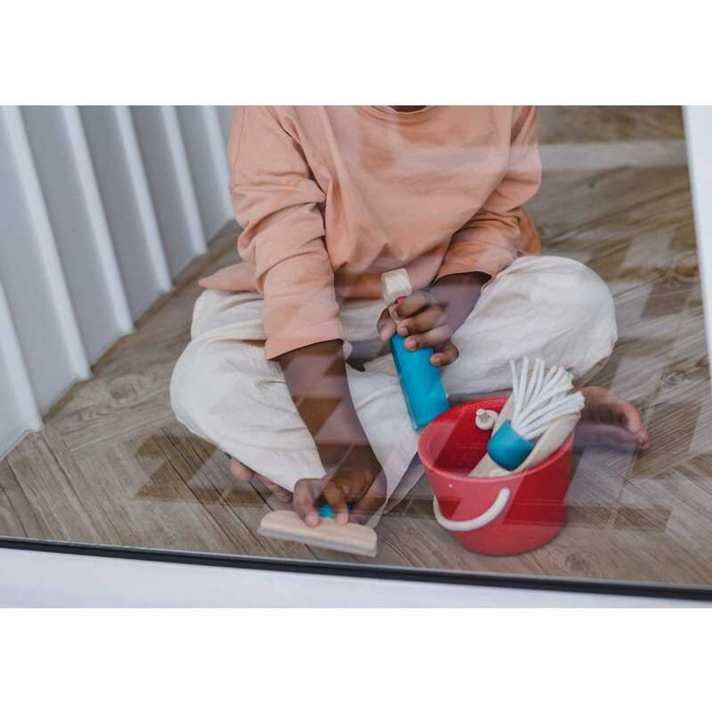 Kid playing PlanToys Cleaning Set
