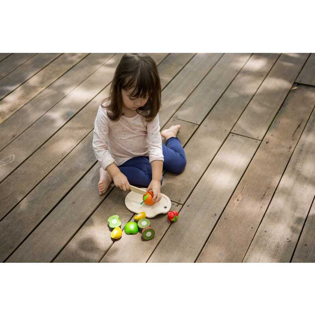 Kid playing PlanToys Assorted Fruit Set