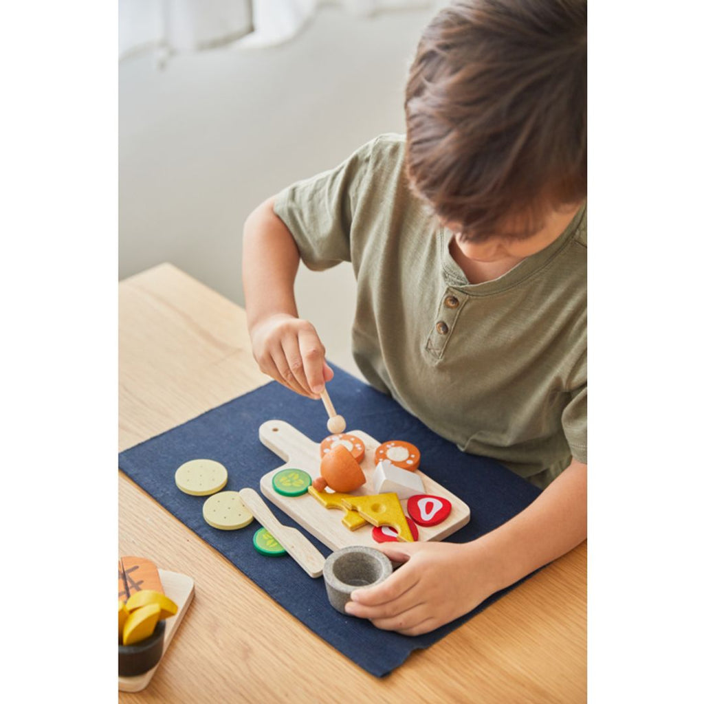 Kid playing PlanToys Cheese & Charcuterie Board