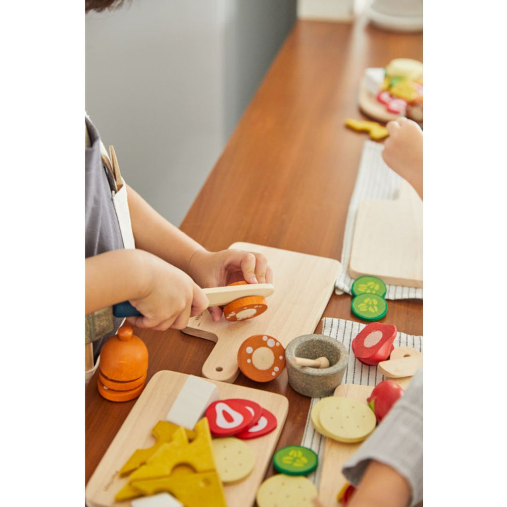 Kid playing PlanToys Cheese & Charcuterie Board