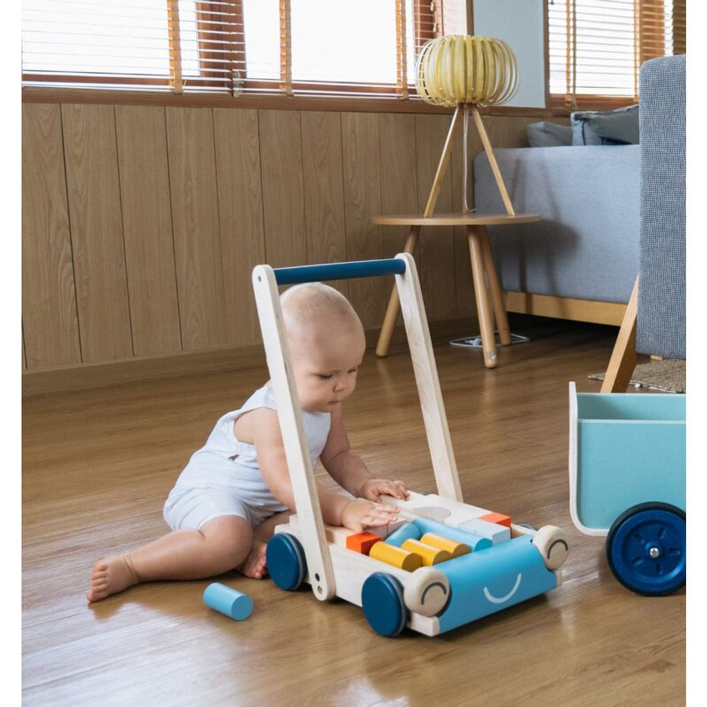 Kid playing PlanToys Baby Walker - Orchard