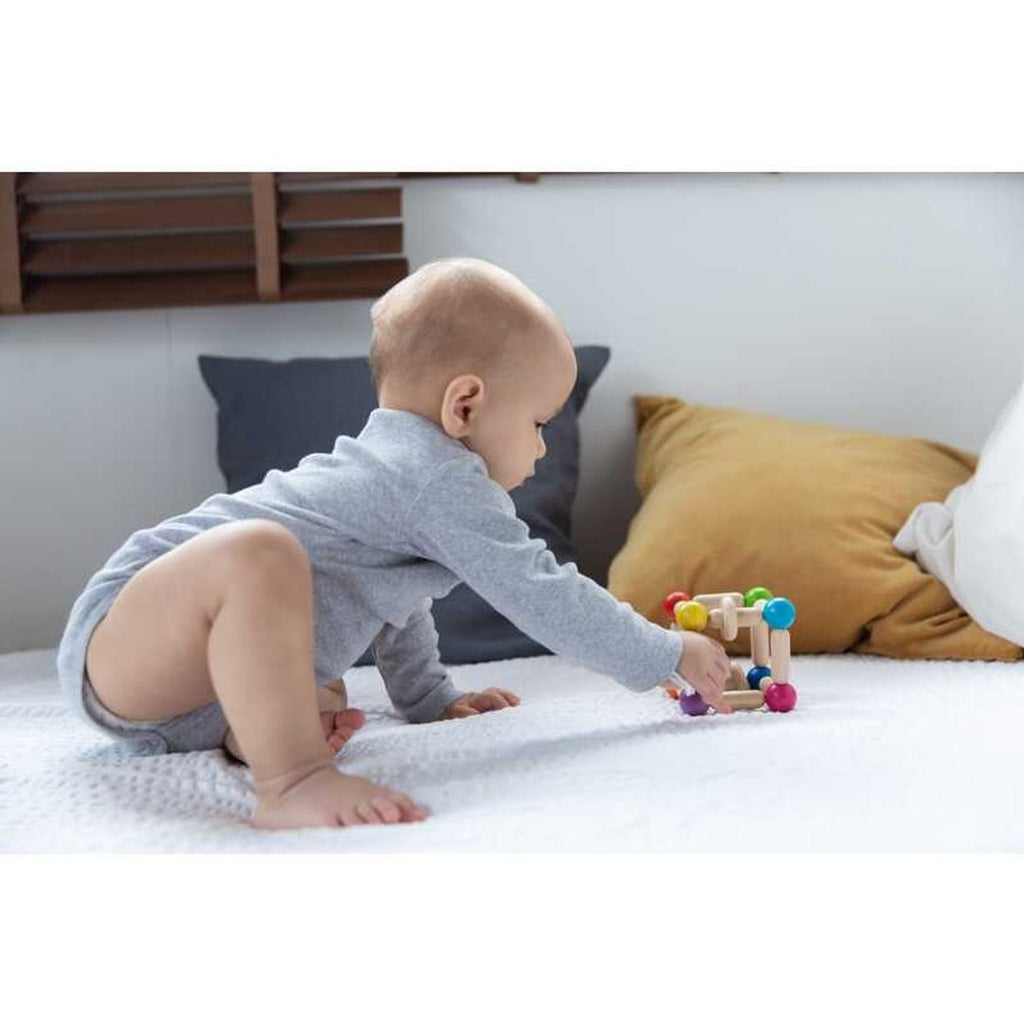 Kid playing PlanToys Square Clutching Toy
