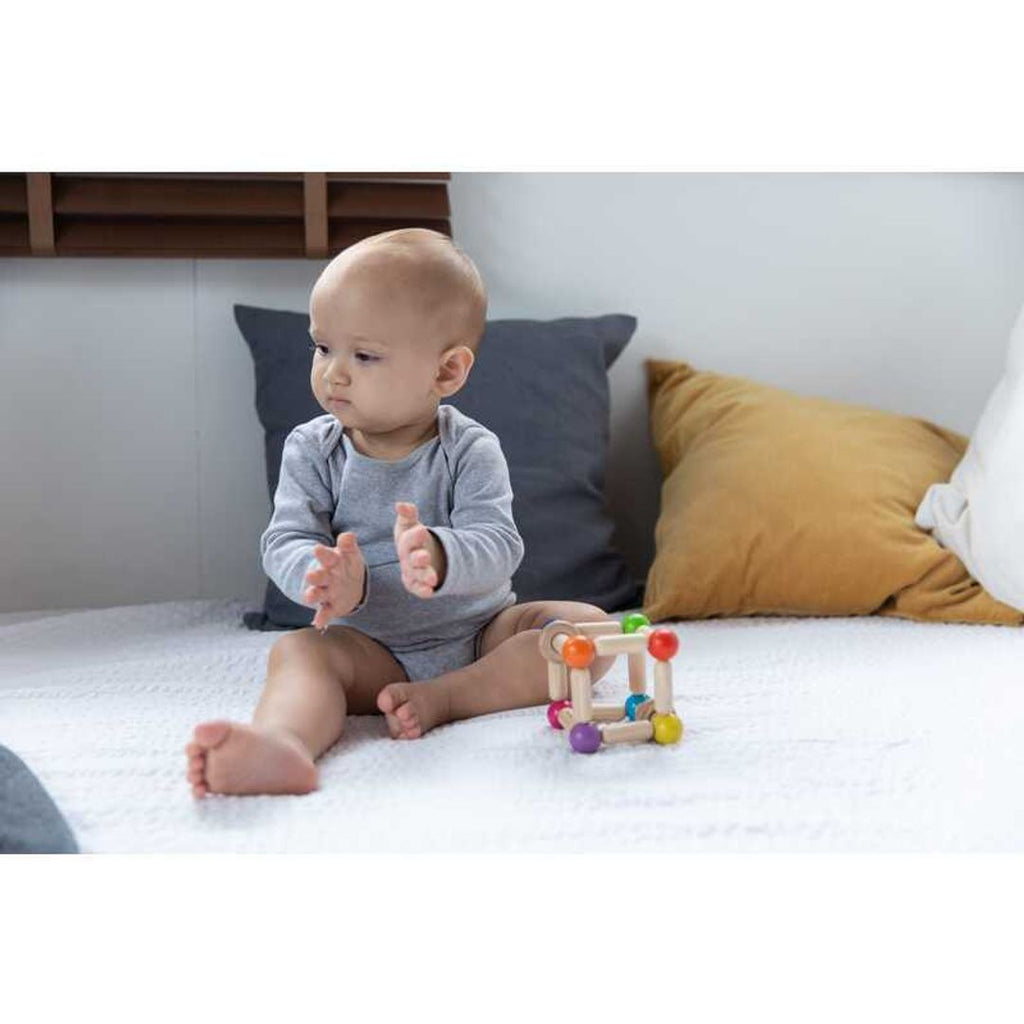 Kid playing PlanToys Square Clutching Toy