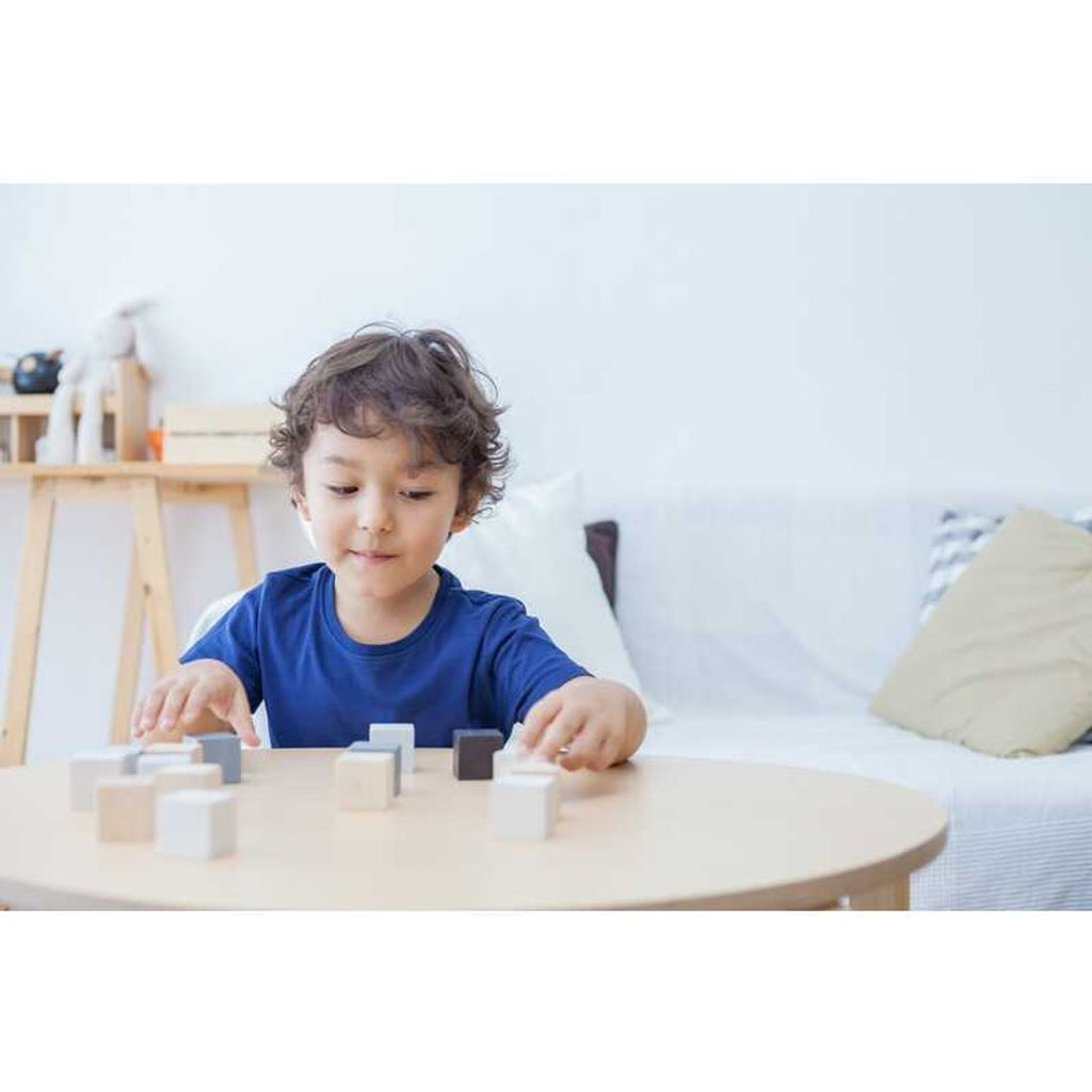Kid playing PlanToys Cubes