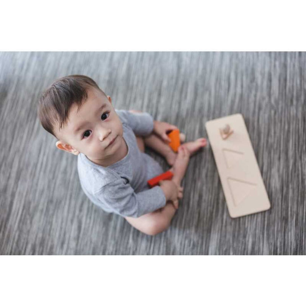 Kid playing PlanToys Triangle Matching Puzzle