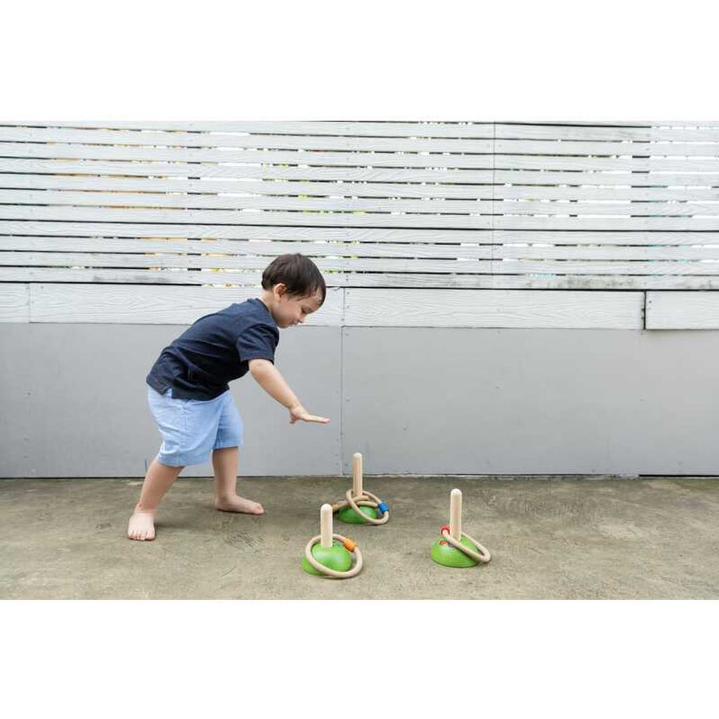 Kid playing PlanToys Meadow Ring Toss