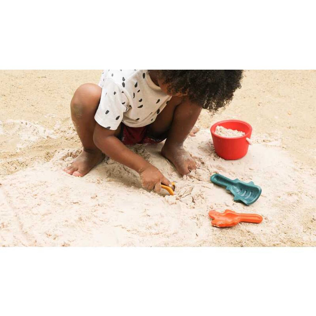 Kid playing PlanToys Sand Play Set