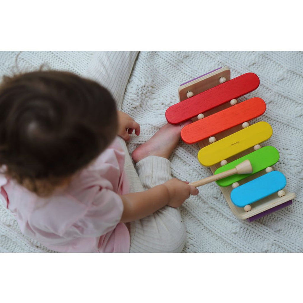 Kid playing PlanToys Oval Xylophone