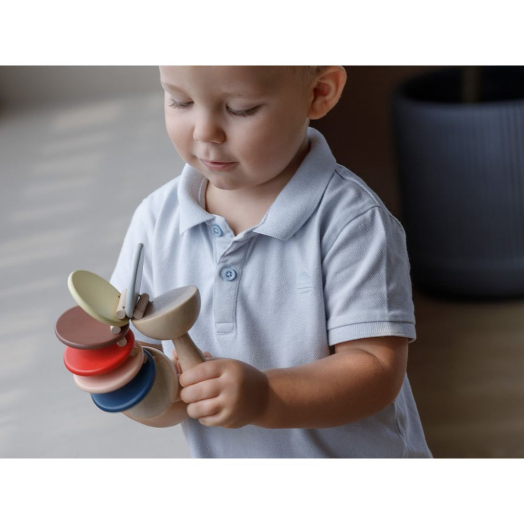 Kid playing PlanToys Clatter - Orchard Series